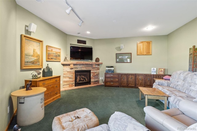 living room featuring recessed lighting, dark carpet, a fireplace, and track lighting