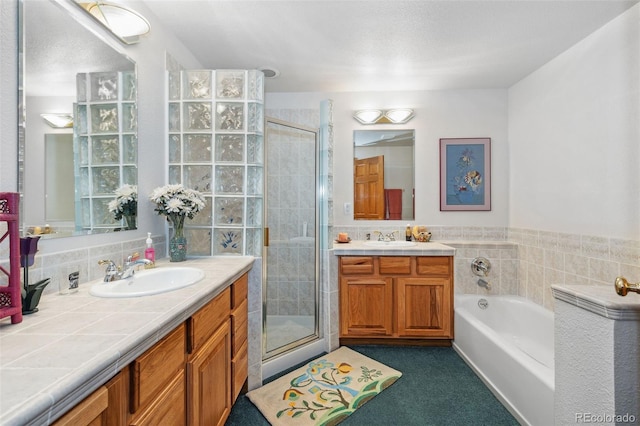 bathroom featuring shower with separate bathtub and vanity