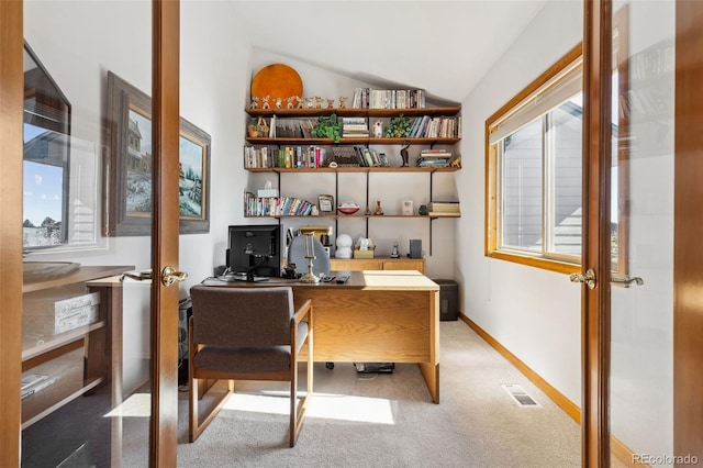 home office with light carpet, french doors, and vaulted ceiling