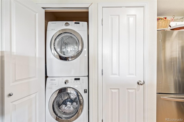 laundry area with stacked washing maching and dryer