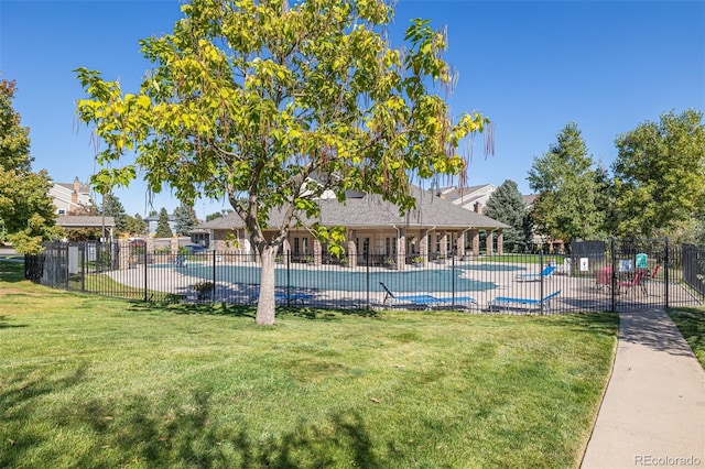 view of pool featuring a lawn