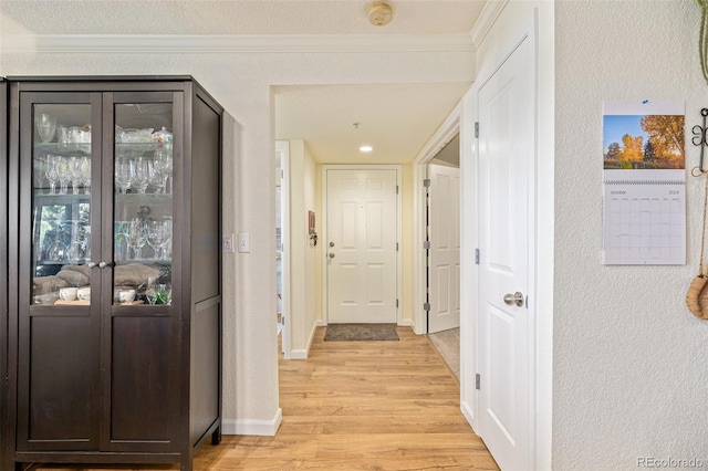 hallway featuring light hardwood / wood-style flooring and a textured ceiling