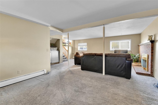 living room with a brick fireplace, washer / dryer, a baseboard radiator, and light colored carpet