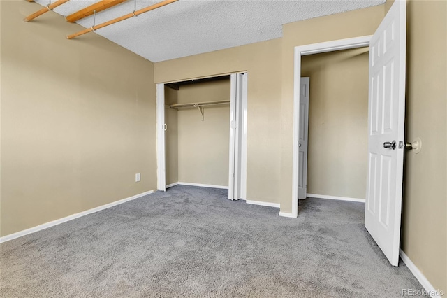 unfurnished bedroom with carpet floors, a closet, and a textured ceiling