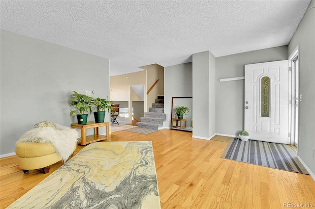 entrance foyer with hardwood / wood-style flooring and a textured ceiling