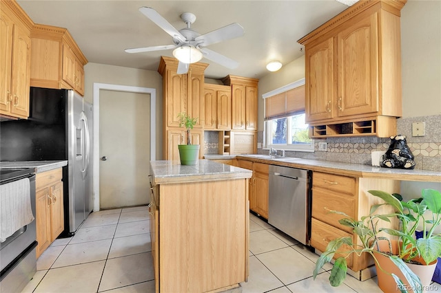 kitchen featuring dishwasher, stove, a center island, tasteful backsplash, and light brown cabinets