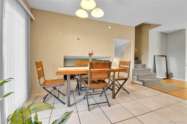 tiled dining room with a textured ceiling