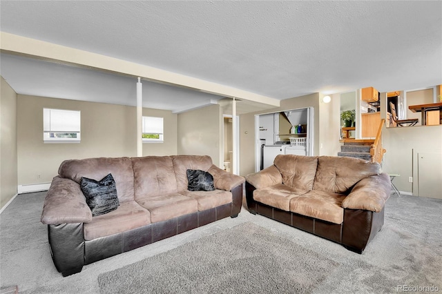 living room featuring a baseboard radiator, separate washer and dryer, carpet floors, and a textured ceiling