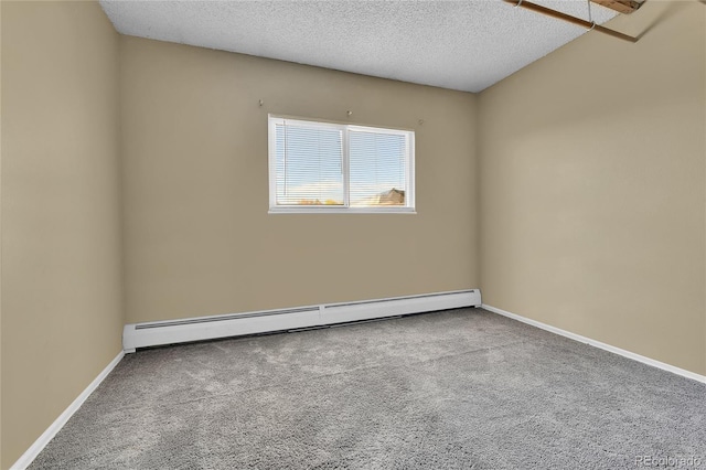 spare room with a baseboard radiator, carpet, and a textured ceiling