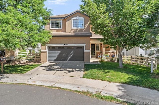 15125 E Bayaud Pl, Aurora, CO 80012 - traditional home with concrete driveway, an attached garage, stucco siding, and a tile roof