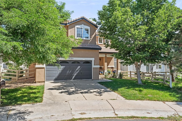 15125 E Bayaud Pl, Aurora, CO 80012 - view of front facade with driveway, a tiled roof, stucco siding, and a garage