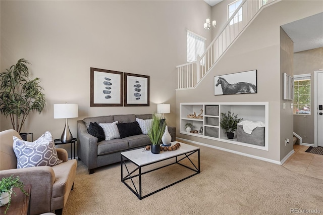 15125 E Bayaud Pl, Aurora, CO 80012 - living room featuring carpet flooring, a towering ceiling, and built in shelves