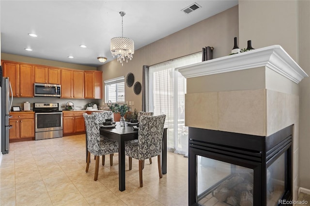 15125 E Bayaud Pl, Aurora, CO 80012 - dining space with a chandelier, recessed lighting, and light tile patterned floors