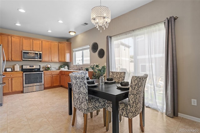15125 E Bayaud Pl, Aurora, CO 80012 - dining area with a chandelier, recessed lighting, and light tile patterned floors