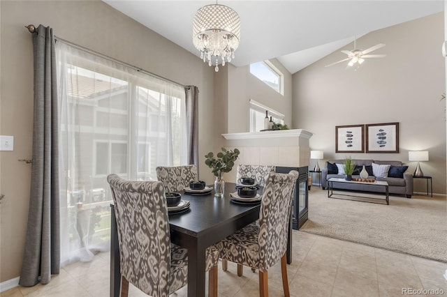 15125 E Bayaud Pl, Aurora, CO 80012 - dining area with light tile patterned floors, light colored carpet, a chandelier, a ceiling fan, and a tiled fireplace