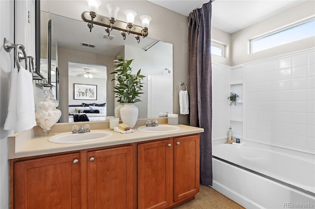 15125 E Bayaud Pl, Aurora, CO 80012 - bathroom featuring double vanity, shower / bath combo with shower curtain, ceiling fan, and ensuite bathroom