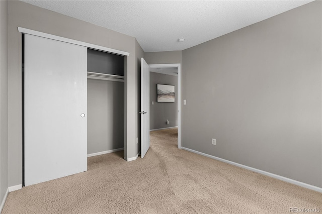 15125 E Bayaud Pl, Aurora, CO 80012 - unfurnished bedroom with carpet floors, a closet, and a textured ceiling