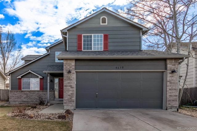 traditional-style house featuring brick siding, roof with shingles, concrete driveway, an attached garage, and fence