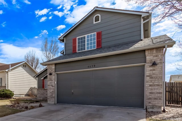 exterior space with a garage, brick siding, fence, concrete driveway, and roof with shingles