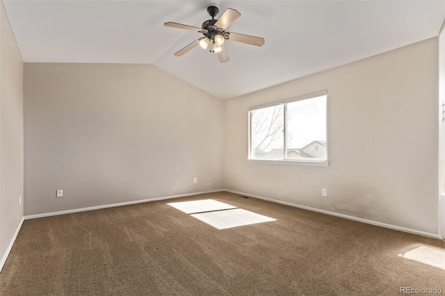 carpeted spare room with a ceiling fan, vaulted ceiling, and baseboards