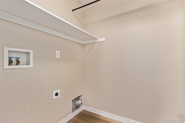 washroom featuring washer hookup, hookup for an electric dryer, wood finished floors, laundry area, and baseboards