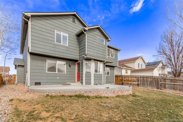 back of property with crawl space, a fenced backyard, and a patio