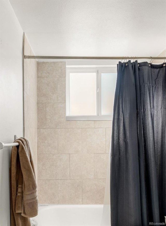 7100 Stuart St, Westminster, CO 80030 - bathroom with shower / bath combination with curtain and a textured ceiling