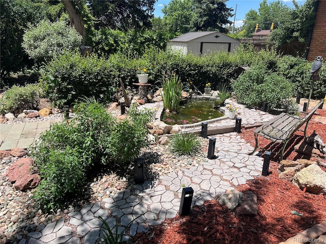 4307 Valli Vista Rd, Colorado Springs, CO 80915 - view of yard featuring a storage unit and a garden pond