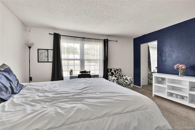 bedroom with a textured ceiling and carpet flooring