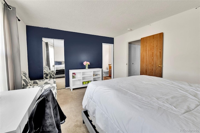 bedroom featuring a textured ceiling and light colored carpet