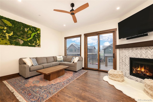 166 Hay Meadow Dr, Fraser, CO 80442 - living area with ceiling fan, wood finished floors, a tiled fireplace, recessed lighting, and baseboards
