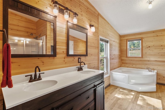 bathroom featuring independent shower and bath, lofted ceiling, wooden walls, and hardwood / wood-style flooring