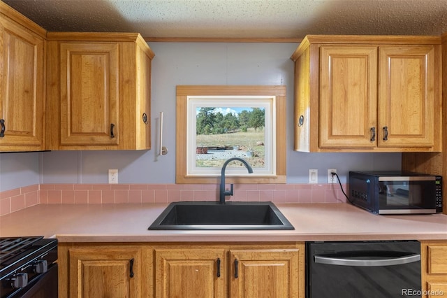 kitchen featuring a textured ceiling, stainless steel appliances, sink, and tasteful backsplash