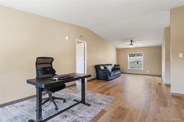 office with a textured ceiling, lofted ceiling, ceiling fan, and light hardwood / wood-style flooring