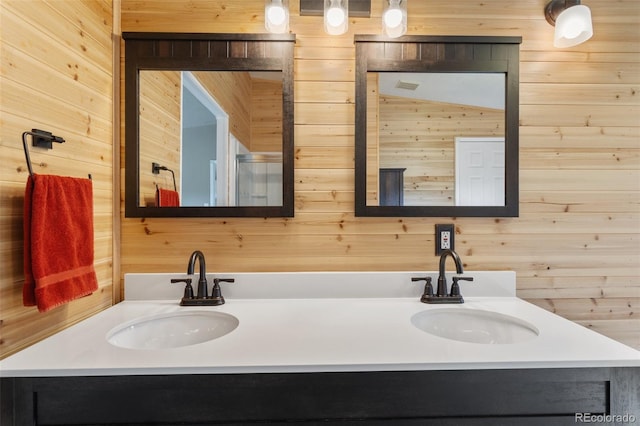 bathroom featuring wood walls, lofted ceiling, and vanity