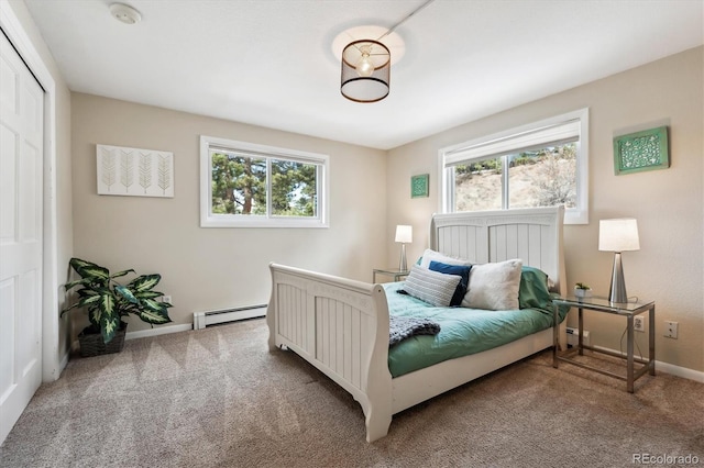 bedroom featuring a baseboard radiator, a closet, and carpet