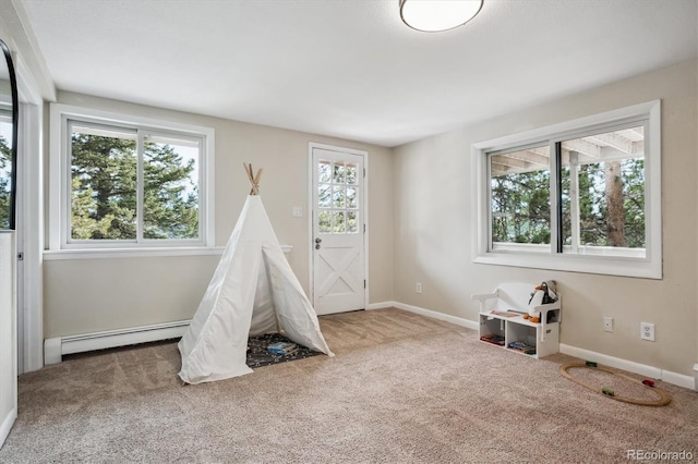 recreation room with a baseboard radiator and carpet floors