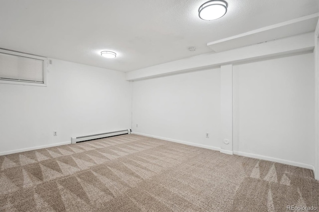 unfurnished room featuring baseboard heating and carpet