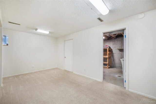 15660 E Purdue Dr, Aurora, CO 80013 - finished basement featuring a textured ceiling, visible vents, and carpet flooring