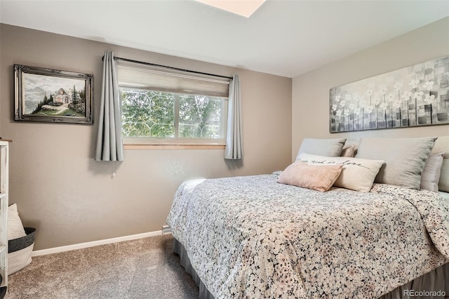 bedroom featuring baseboards and carpet