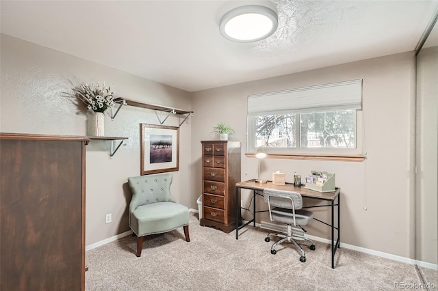 carpeted home office featuring baseboards