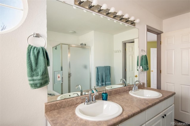 bathroom with vanity and a shower with shower door