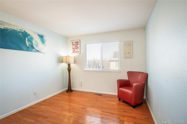 sitting room with hardwood / wood-style flooring