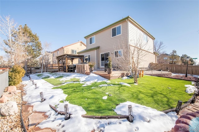 back of property featuring a gazebo and a yard