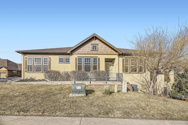 view of front of house featuring stucco siding and a porch