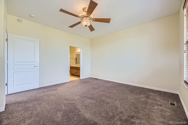 unfurnished bedroom with a ceiling fan, baseboards, visible vents, ensuite bath, and light carpet