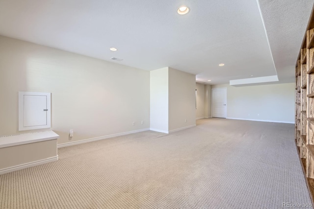 empty room with recessed lighting, baseboards, light carpet, and visible vents