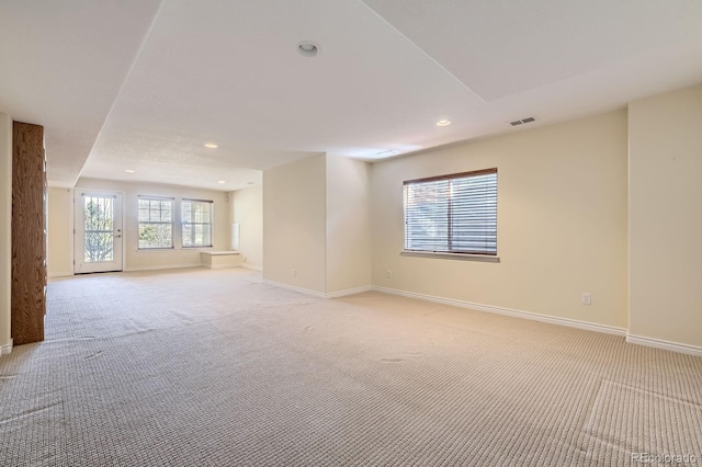 spare room featuring recessed lighting, baseboards, visible vents, and light carpet