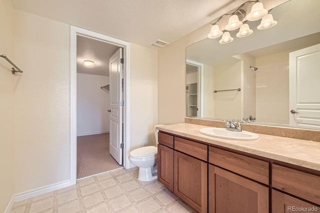 bathroom featuring walk in shower, toilet, vanity, tile patterned floors, and a textured ceiling