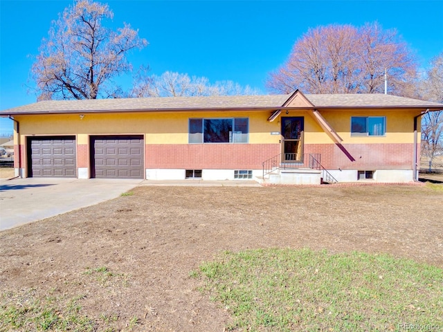 ranch-style home featuring a garage, concrete driveway, and brick siding